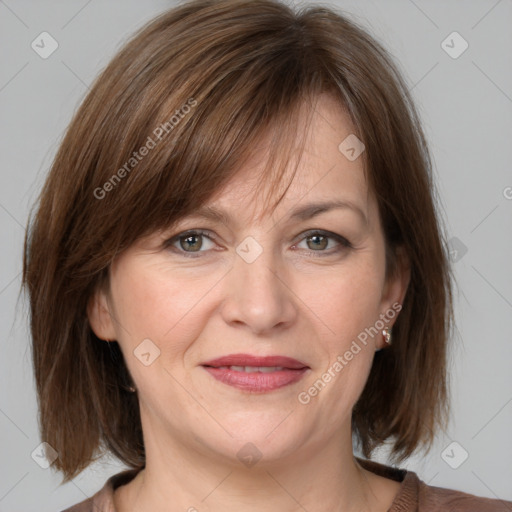 Joyful white adult female with medium  brown hair and grey eyes