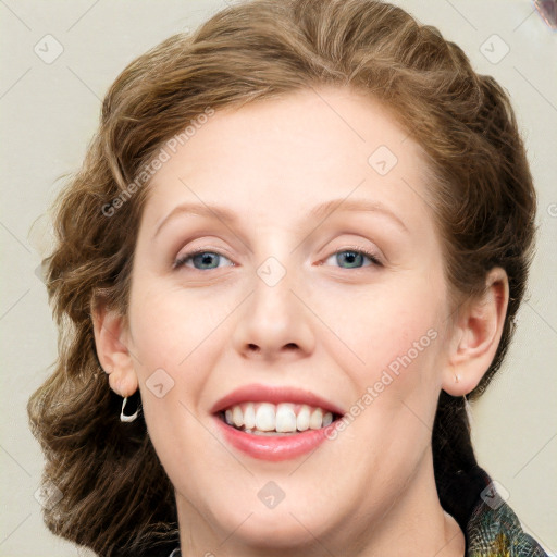 Joyful white young-adult female with medium  brown hair and blue eyes