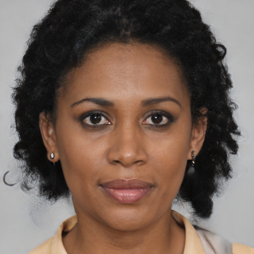Joyful black young-adult female with medium  brown hair and brown eyes