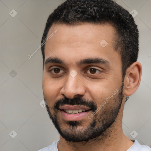 Joyful black young-adult male with short  black hair and brown eyes