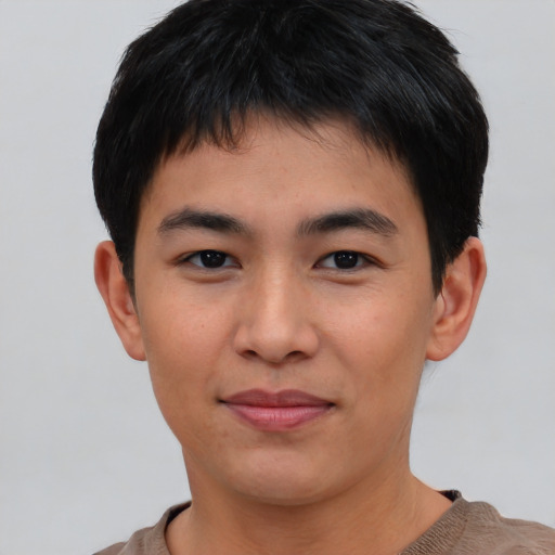 Joyful asian young-adult male with short  brown hair and brown eyes