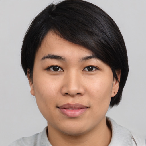 Joyful asian young-adult female with medium  black hair and brown eyes