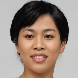 Joyful asian young-adult female with medium  black hair and brown eyes