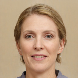 Joyful white adult female with medium  brown hair and grey eyes