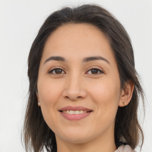 Joyful white young-adult female with long  brown hair and brown eyes