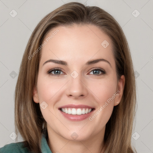 Joyful white young-adult female with long  brown hair and grey eyes