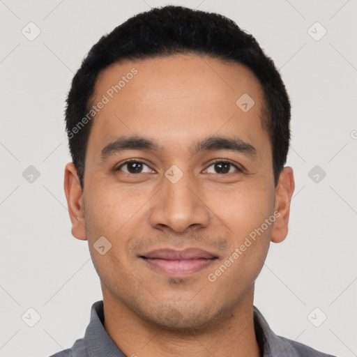 Joyful latino young-adult male with short  black hair and brown eyes