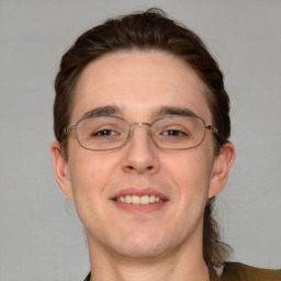 Joyful white adult male with short  brown hair and blue eyes