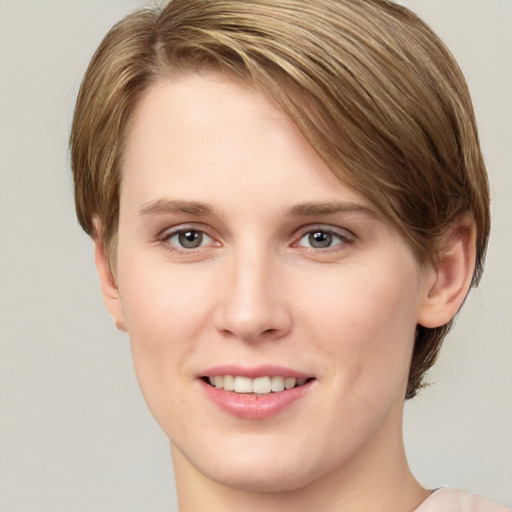 Joyful white young-adult female with short  brown hair and green eyes