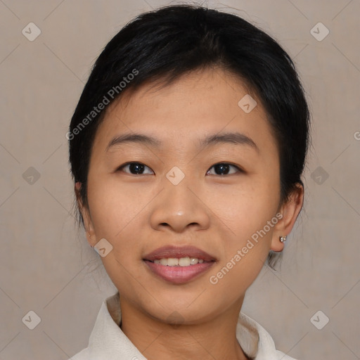 Joyful asian young-adult female with short  black hair and brown eyes