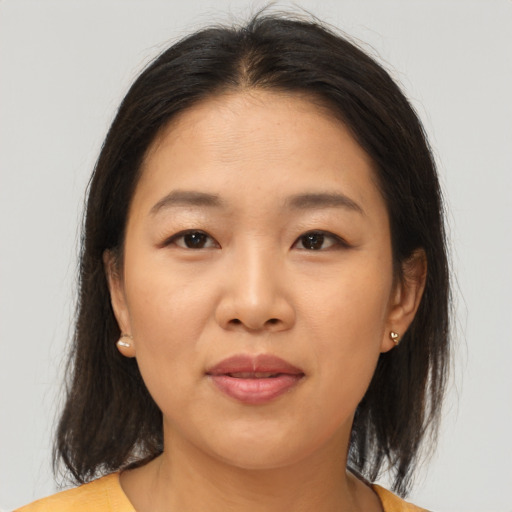Joyful asian young-adult female with medium  brown hair and brown eyes