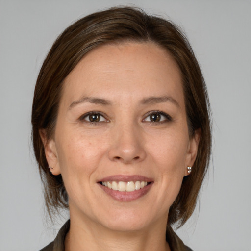 Joyful white adult female with medium  brown hair and brown eyes