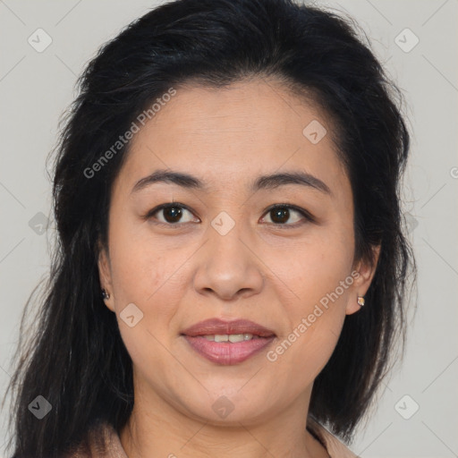 Joyful latino adult female with medium  brown hair and brown eyes