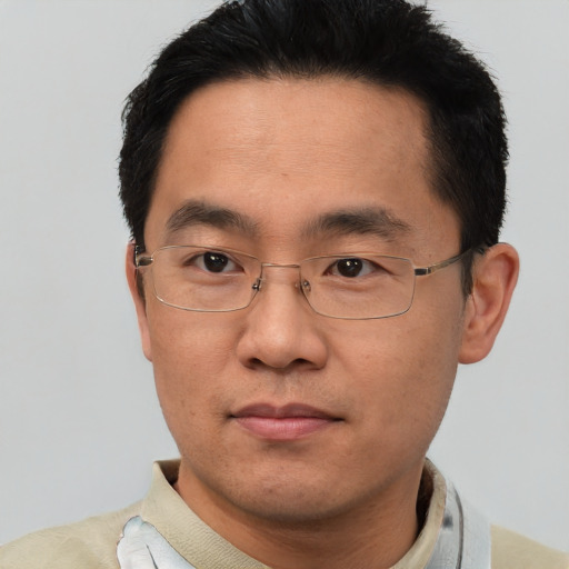 Neutral asian adult male with short  brown hair and brown eyes