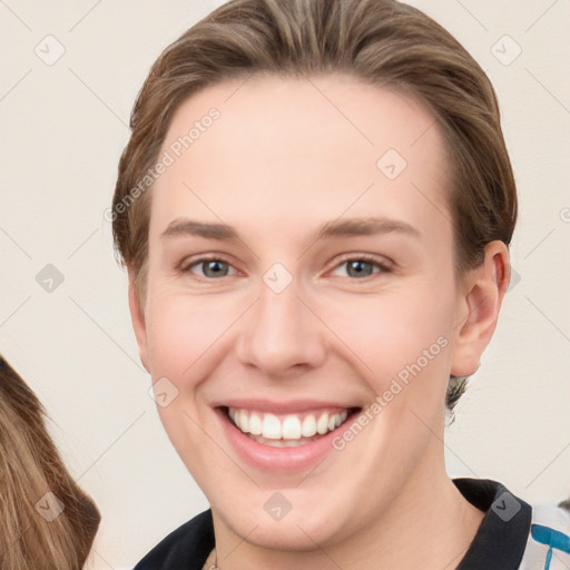 Joyful white young-adult female with short  brown hair and grey eyes