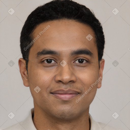 Joyful black young-adult male with short  black hair and brown eyes