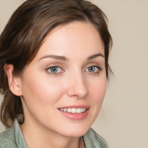 Joyful white young-adult female with medium  brown hair and blue eyes