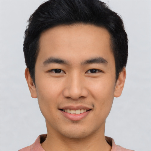 Joyful asian young-adult male with short  black hair and brown eyes