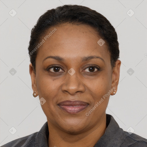 Joyful black adult female with short  black hair and brown eyes