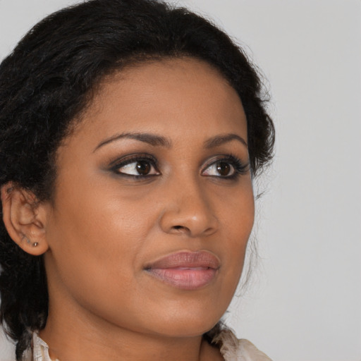 Joyful black young-adult female with medium  brown hair and brown eyes