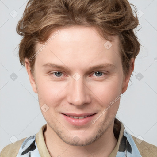 Joyful white young-adult male with short  brown hair and blue eyes