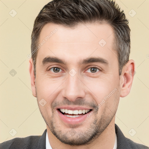 Joyful white young-adult male with short  brown hair and brown eyes