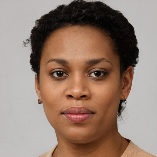Joyful black young-adult female with short  brown hair and brown eyes