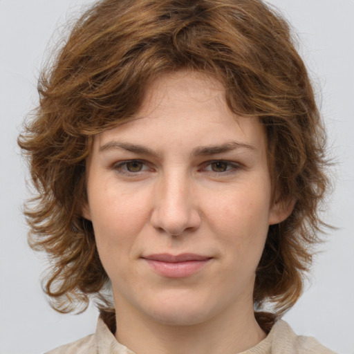 Joyful white young-adult female with medium  brown hair and green eyes