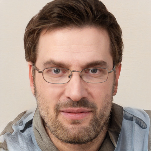 Joyful white adult male with short  brown hair and blue eyes