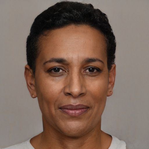 Joyful black adult female with short  black hair and brown eyes