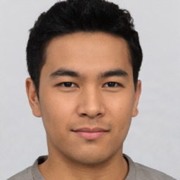 Joyful asian young-adult male with short  black hair and brown eyes