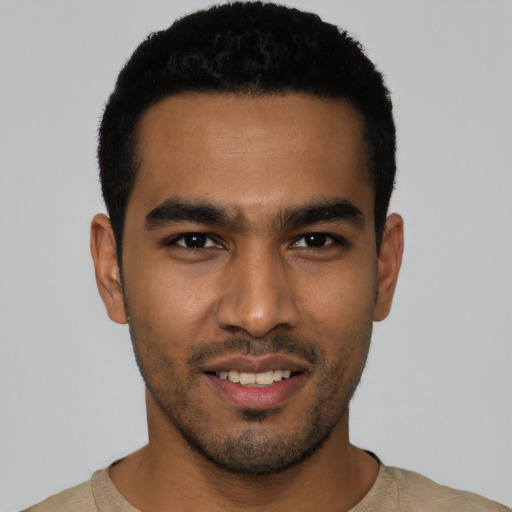 Joyful latino young-adult male with short  black hair and brown eyes