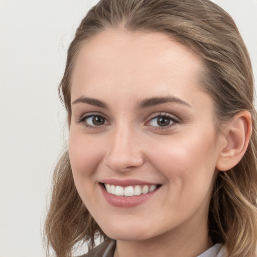 Joyful white young-adult female with long  brown hair and grey eyes