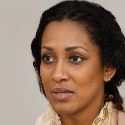 Joyful black adult female with medium  brown hair and brown eyes