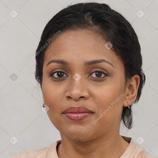 Joyful black young-adult female with medium  brown hair and brown eyes