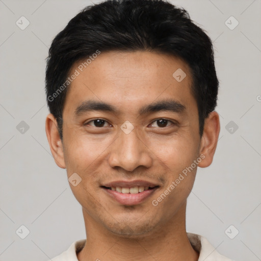 Joyful asian young-adult male with short  black hair and brown eyes