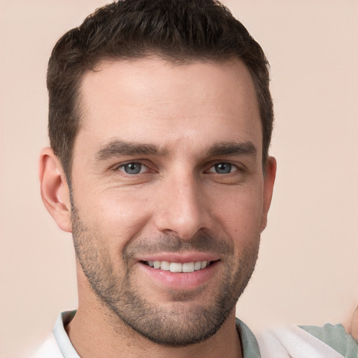 Joyful white young-adult male with short  brown hair and brown eyes