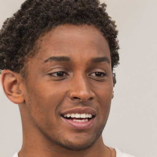 Joyful black young-adult male with short  brown hair and brown eyes