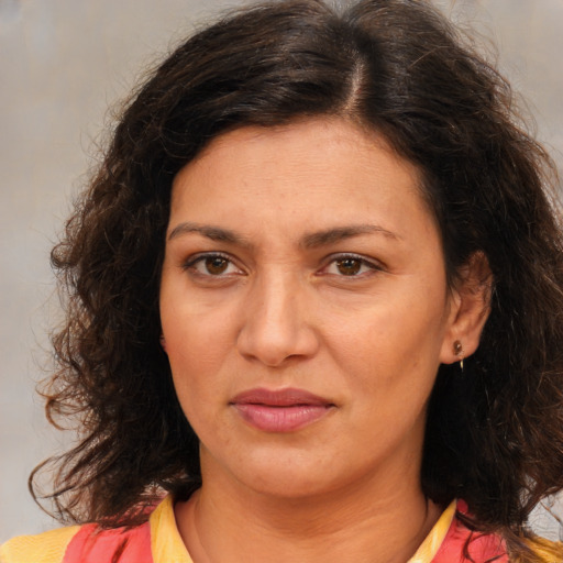 Joyful white adult female with medium  brown hair and brown eyes