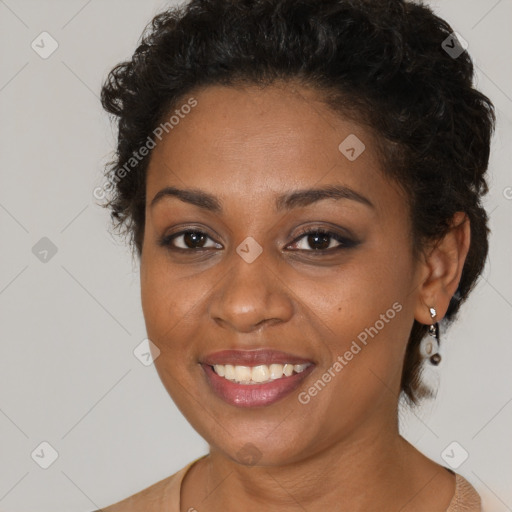 Joyful black young-adult female with short  brown hair and brown eyes