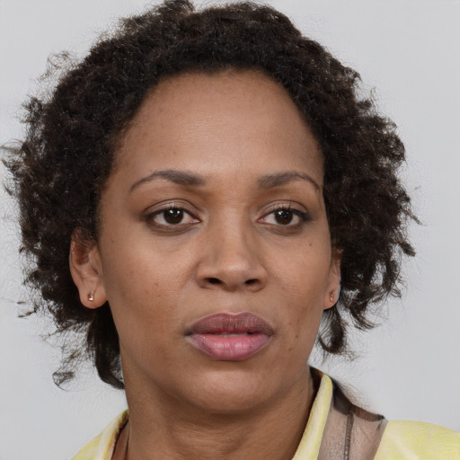 Neutral black adult female with medium  brown hair and brown eyes