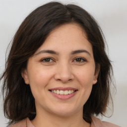 Joyful white adult female with medium  brown hair and brown eyes