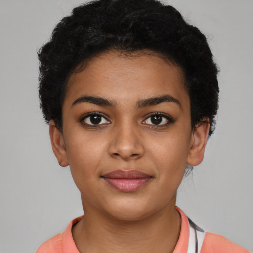 Joyful latino young-adult female with short  black hair and brown eyes