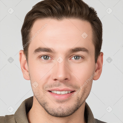 Joyful white young-adult male with short  brown hair and grey eyes