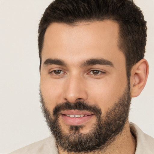 Joyful white young-adult male with short  black hair and brown eyes