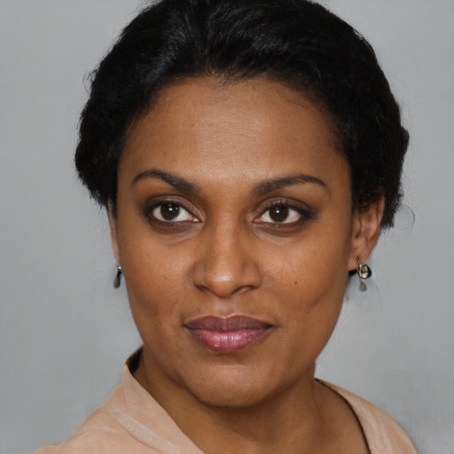 Joyful black young-adult female with short  black hair and brown eyes