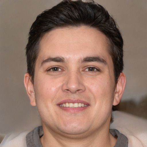 Joyful white adult male with short  brown hair and brown eyes