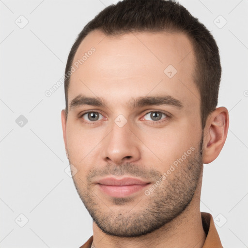 Joyful white young-adult male with short  brown hair and brown eyes