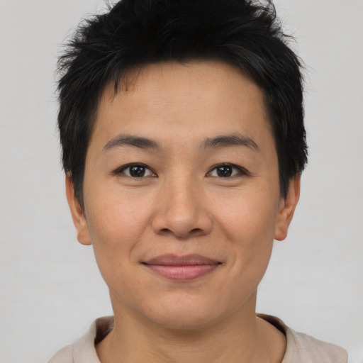 Joyful asian young-adult male with short  brown hair and brown eyes