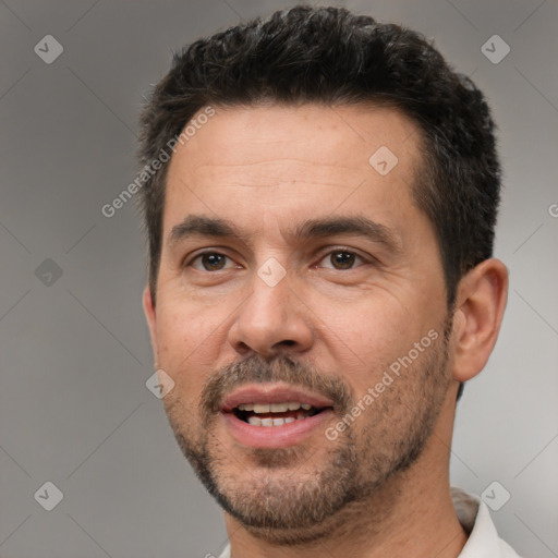 Joyful white adult male with short  brown hair and brown eyes